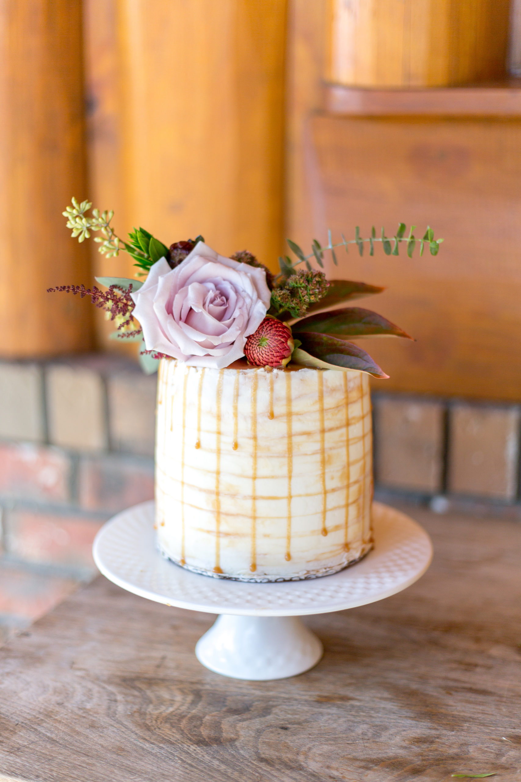Detail shot of a gorgeous wedding cake topped with flowers for a BC elopement photoshoot