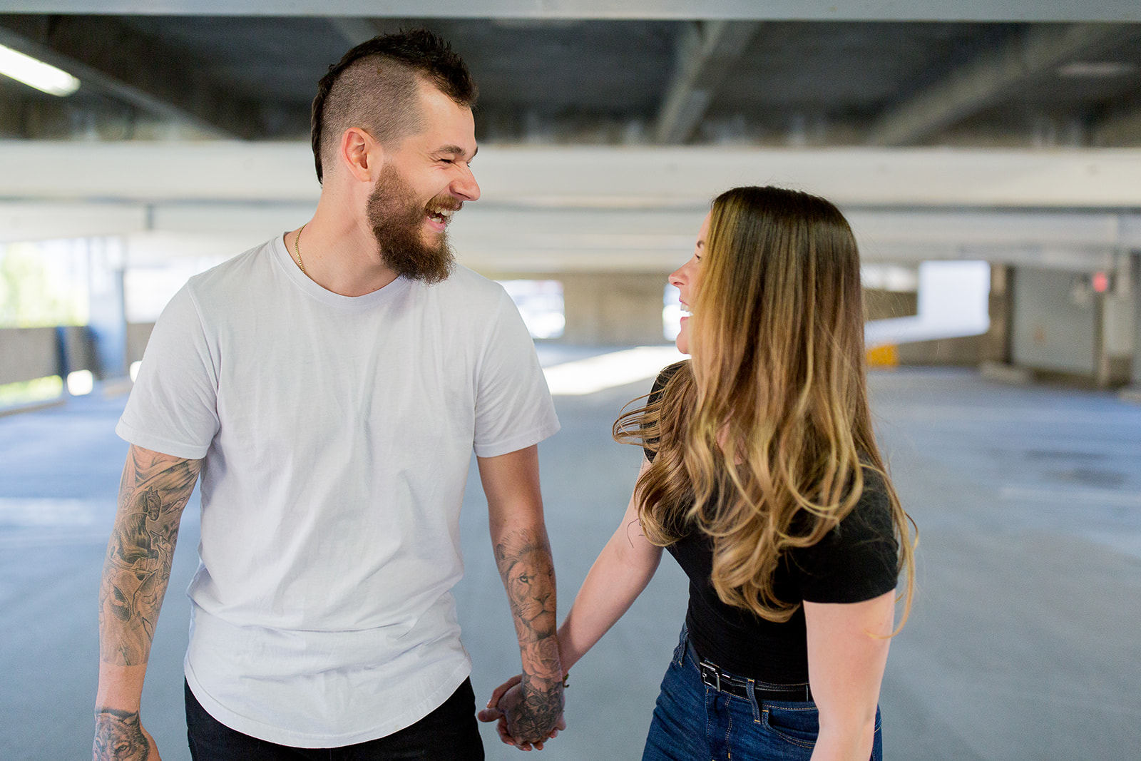 Couple laughs together in a parkade during their photoshoot in BC
