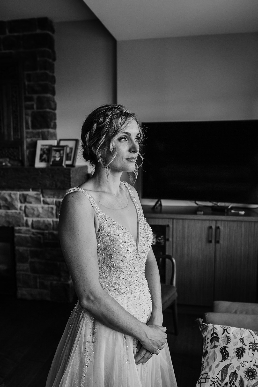 Black and white portrait of a bride on her wedding day in wearing a v-neck beaded bridal dress