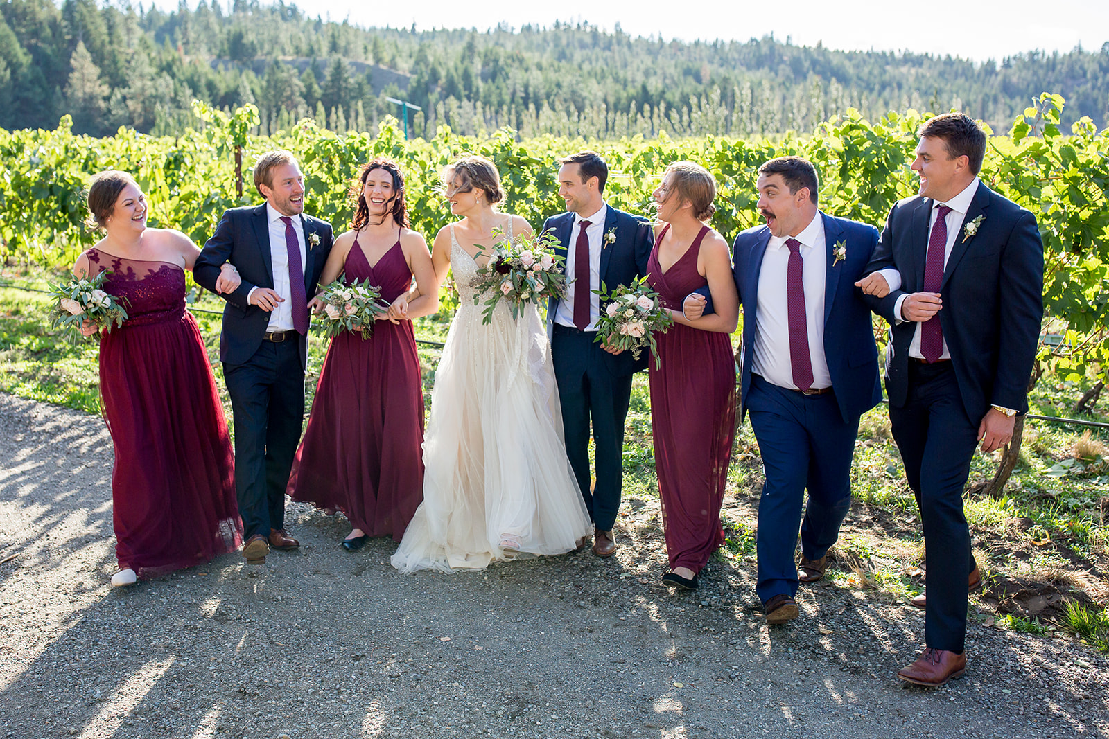 Bride, groom, and their bridal party pose outside at the Monte Creek Winery in BC in celebration of this special day