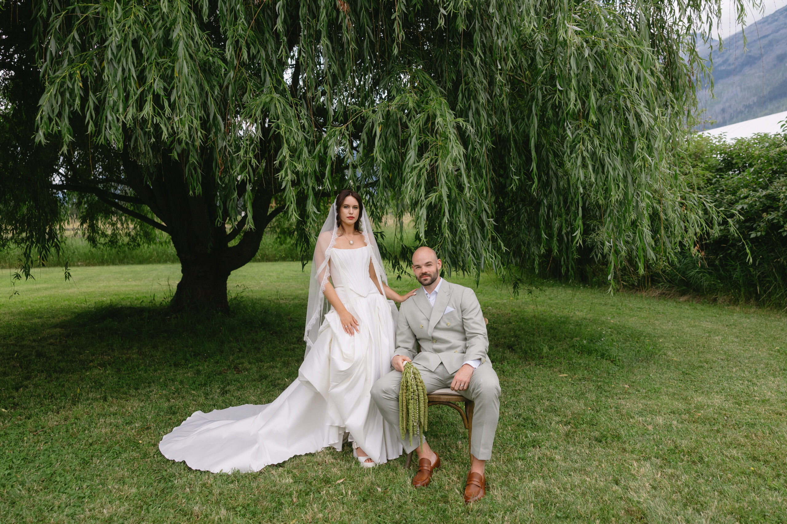 modern-editorial-luxury-wedding-whistler-british-columbia-bride-and-groom-standing-in-front-of-willow-tree-in-wedding-attire