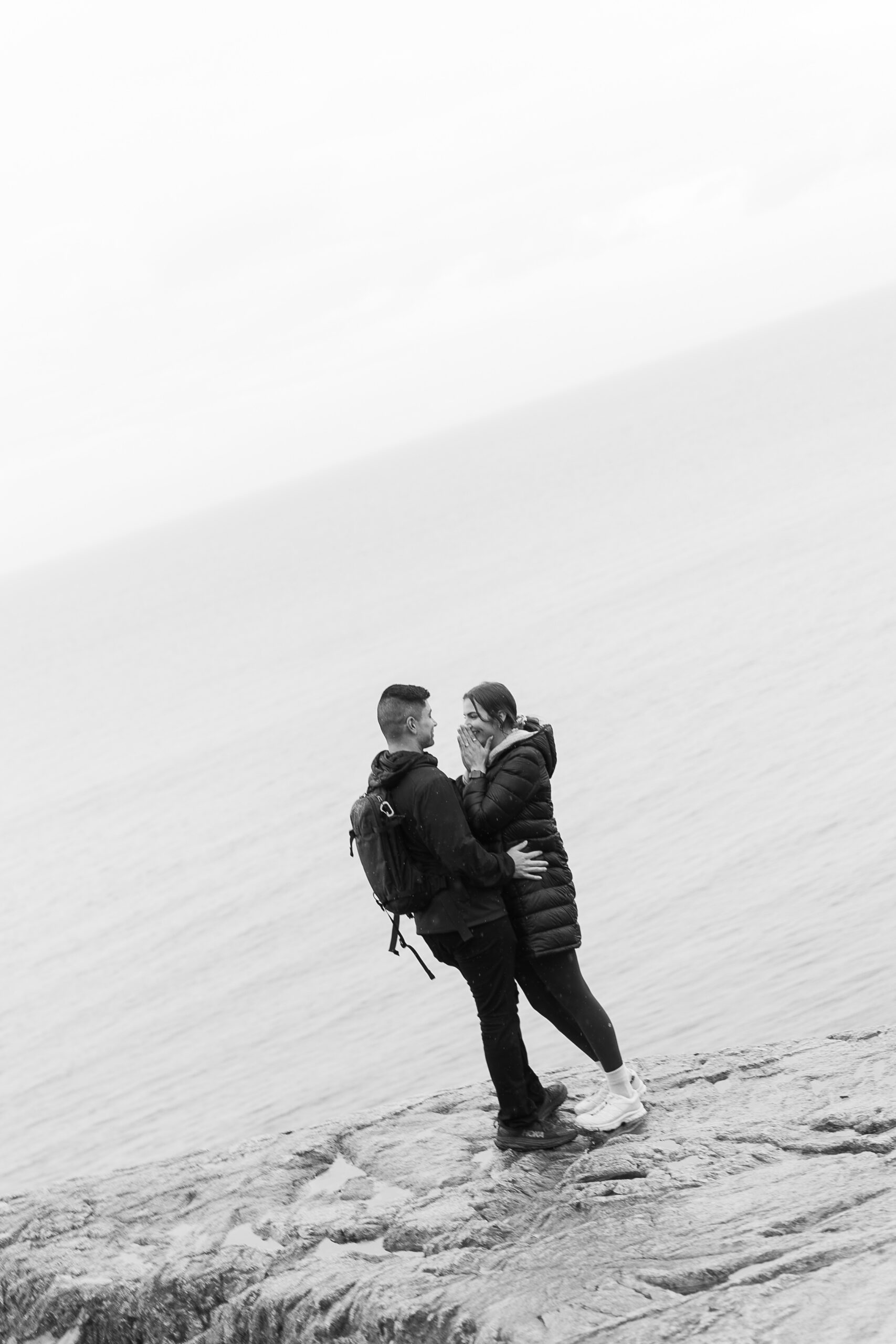 couple saying yes at proposal at lighthouse park vancouver