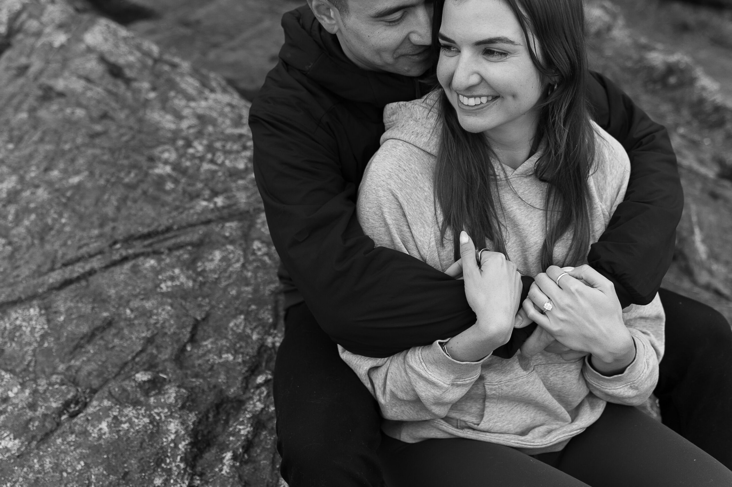 couple hugging after wedding proposal at lighthouse park vancouver