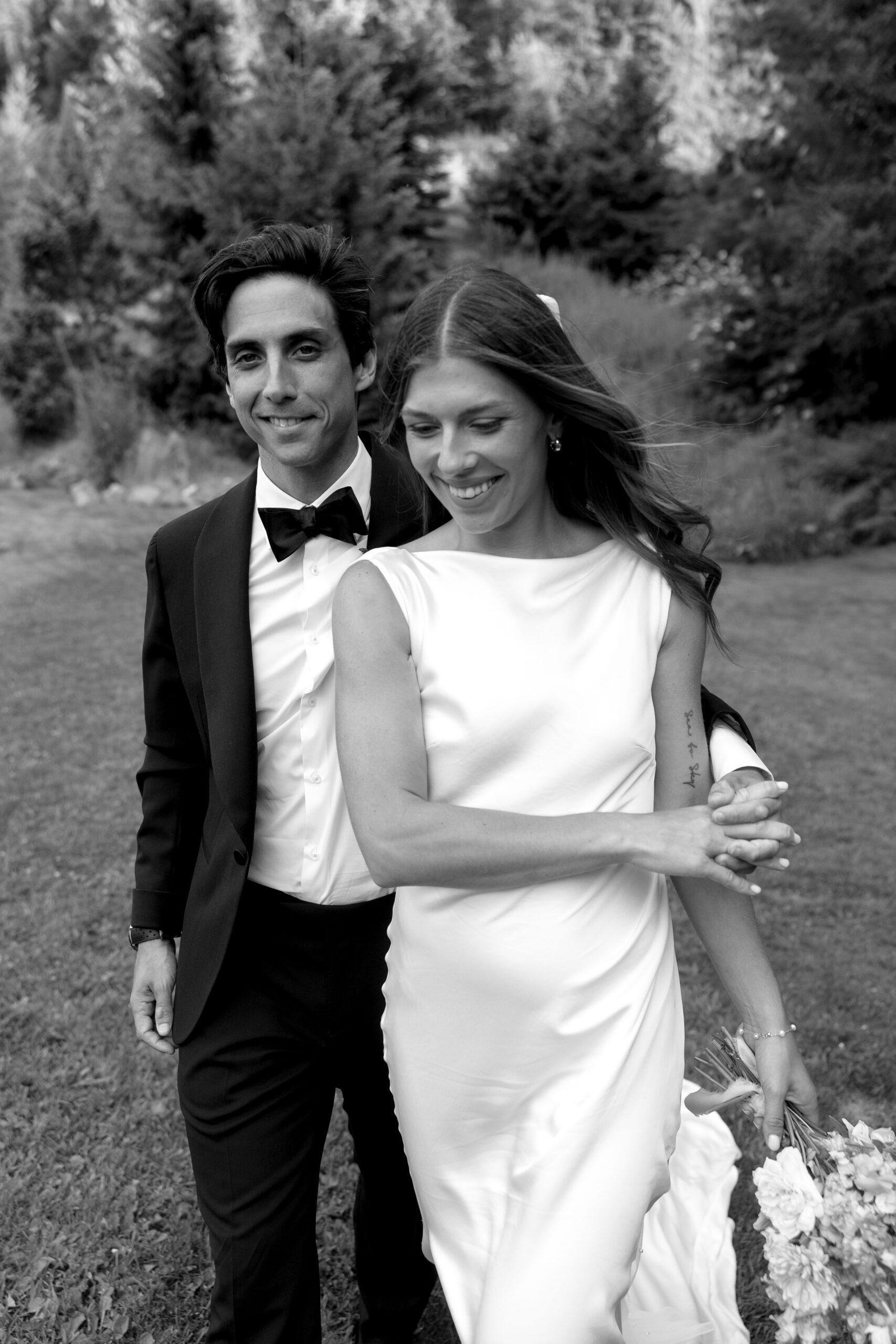 bride and groom posing for wedding portraits in the field at wedge mountain lodge 
