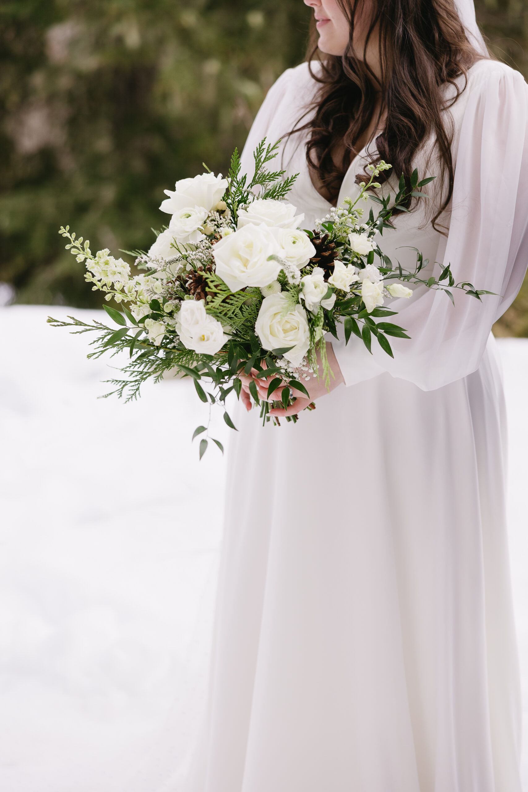 bride holding flowers during portraits at wedge mountain lodge for winter wedding